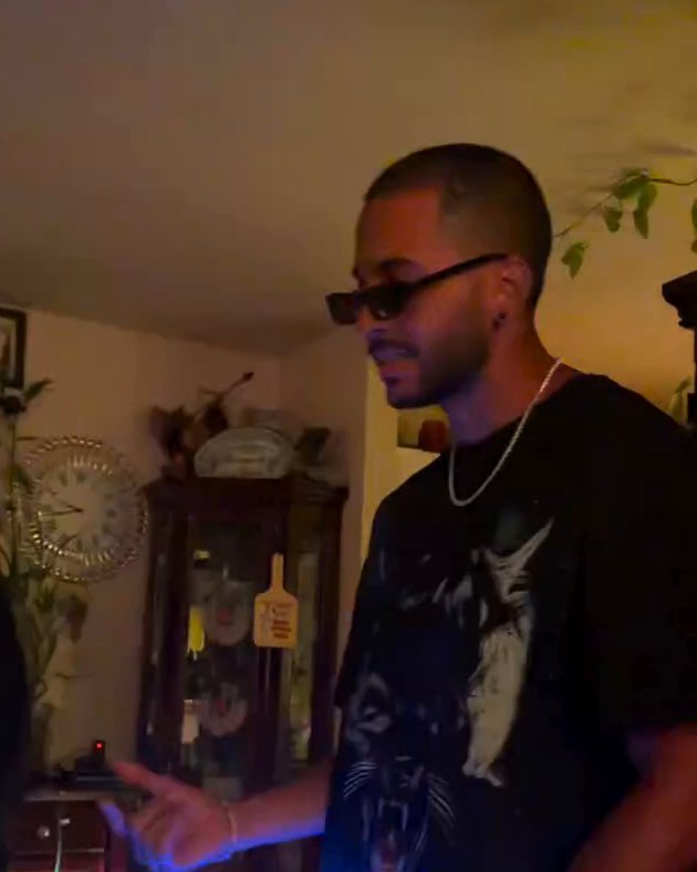DJ Maduro in sunglasses mixing at a private party